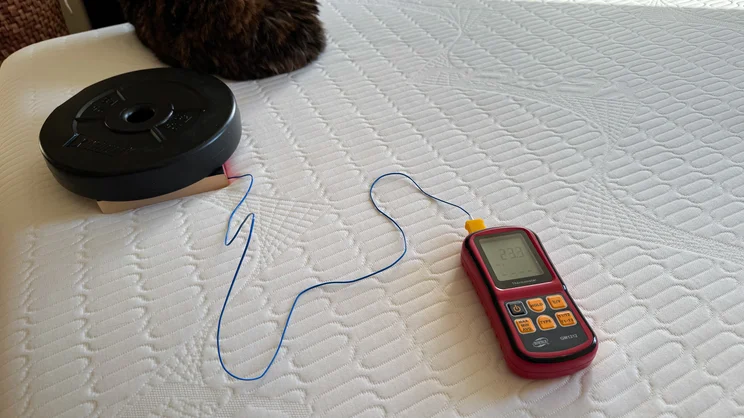 A thermocouple thermometer, probe and weight being used to test the surface temperature of the REM-Fit Pocket 1000 Hybrid mattress