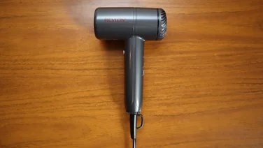 A bird's eye view of the Revlon One Step Power Move hair dryer, on a wooden table