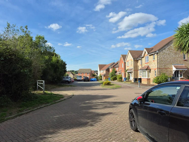 A quiet close of houses on a bright day