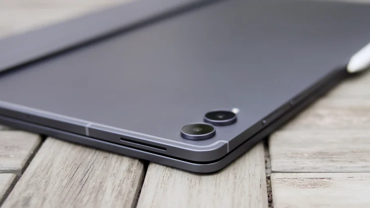Low-angle view of the Samsung Galaxy Tab S12 Ultra's back corner with its two camera lenses, a speaker grille and the edge of the stylus.