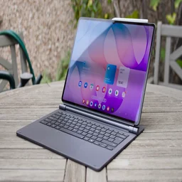 Samsung Galaxy Tab S12 Ultra propped up in its keyboard cover like a laptop on a weathered wooden garden table