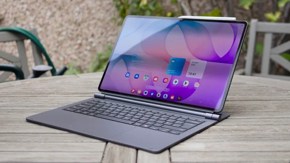 Samsung Galaxy Tab S12 Ultra propped up in its keyboard cover like a laptop on a weathered wooden garden table