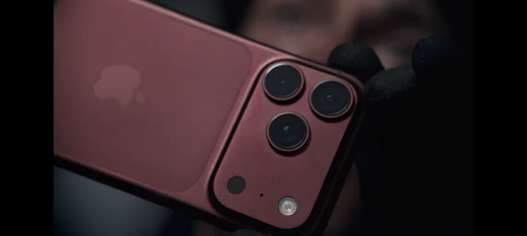 The burgundy iPhone 18 Pro against a dark moody background
