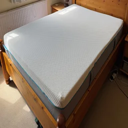 The Simba Simbatex Cool mattress on a wooden bed frame in a bedroom