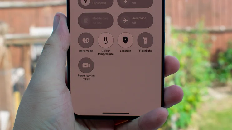 TCL P80 Ultra in hand, displaying quick menu settings