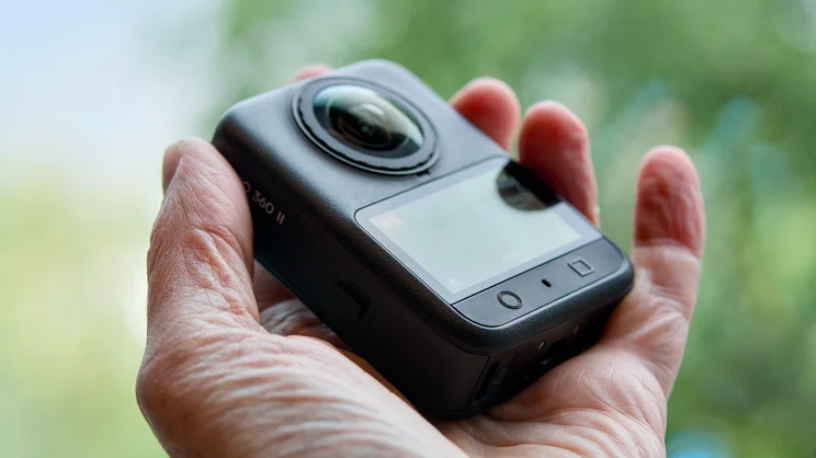 The DJI Osmo 360 II pictured being held in hand, from the rear