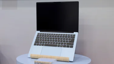 The Dell 14S pictured on a laptop stand, open