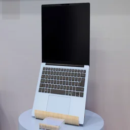 The Dell 14S pictured on a laptop stand, open