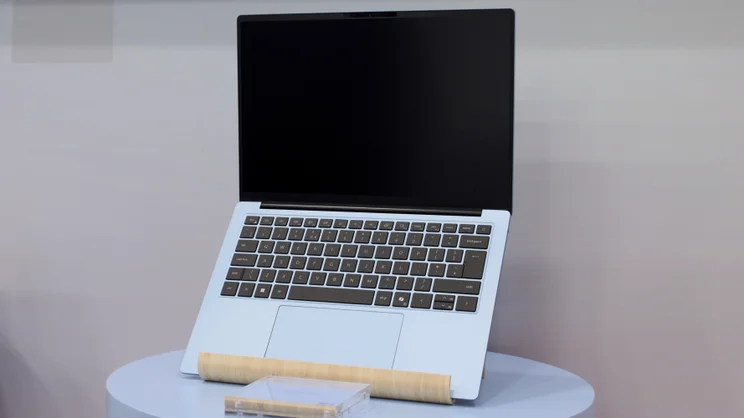 The Dell 14S pictured on a laptop stand, open