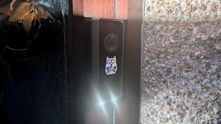 The Ezviz EP8 Ultra mounted on a door frame with lower lights illuminated