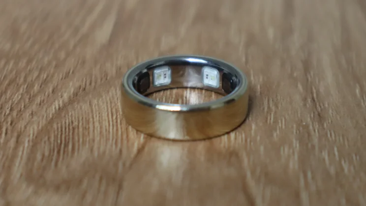 The Oura ring 5 picutred on a wood surface showing the inside surface