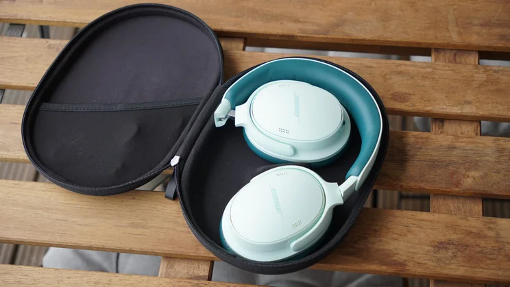The Bose QuietComfort Headphones 2nd Gen inside the open carrying case 