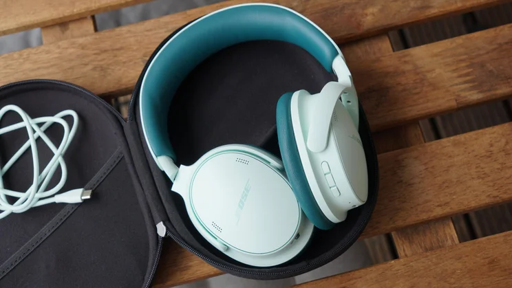The Bose QuietComfort Headphones 2nd Gen in their carrying case with a cable 