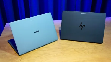 The HP Googlebook 14 and Asus Googlebook 14 on a wooden desk