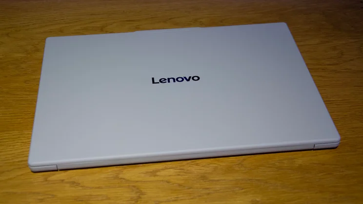 The Lenovo Googlebook 15 clamshell laptop with its lid closed on a wooden desk