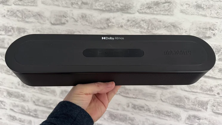 The Majority Bowfell Halo Atmos soundbar being held in one hand