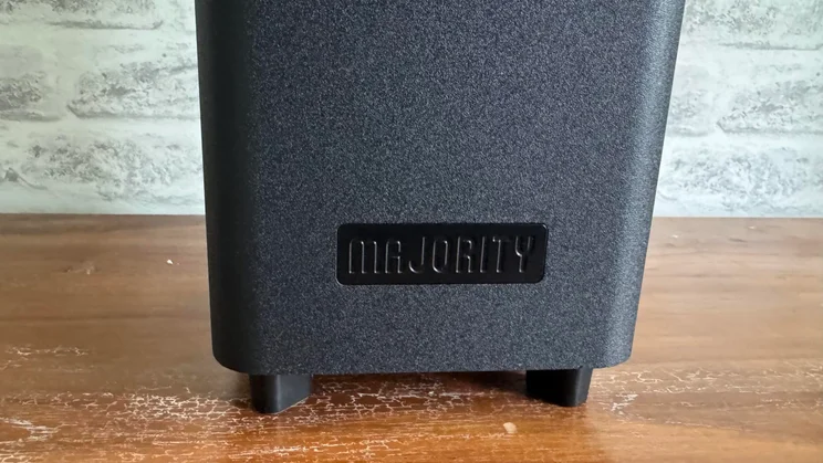 Close-up of the Majority logo on the front of the subwoofer included in the Majority Bowfell Halo Atmos soundbar system