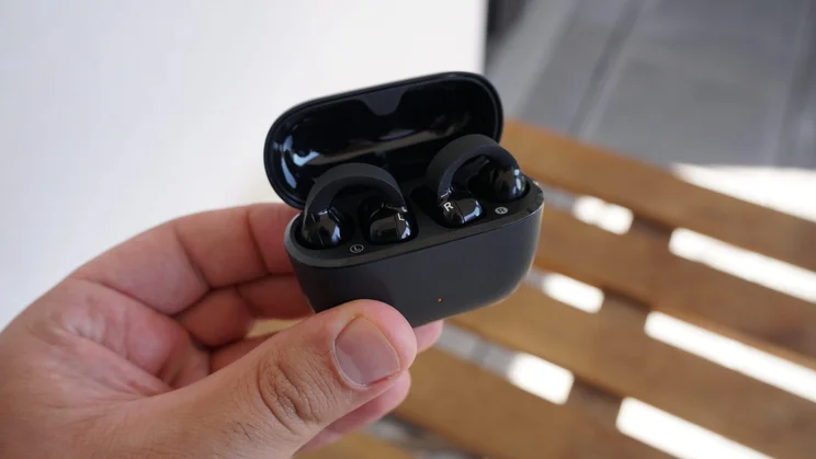 The charging case of the Sennheiser Accentum Clip clip-on earbuds open with the buds inside