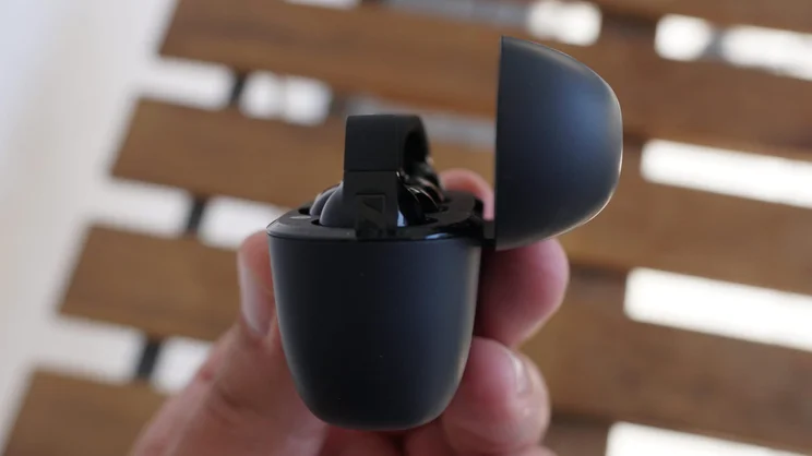 Side view of the charging case of the Sennheiser Accentum Clip clip-on earbuds open with the buds inside
