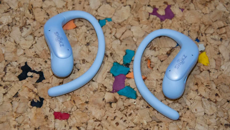 The Shokz OpenFit Air 2 laid flat on a cork table