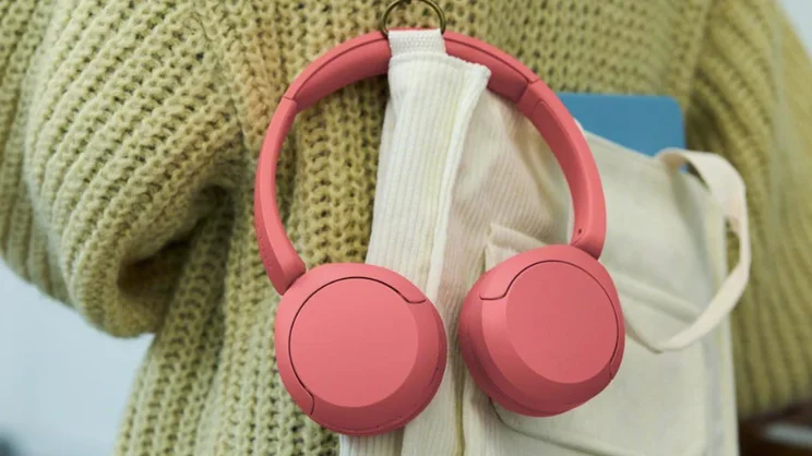 Lifestyle shot of the Sony WH-CH530 on-ear headphones hanging from a bag