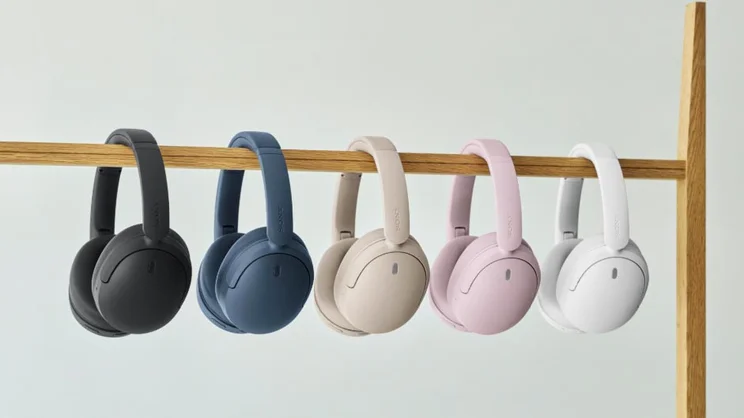 The five different colour options of the Sony WH-CH730N hanging on a wooden railing