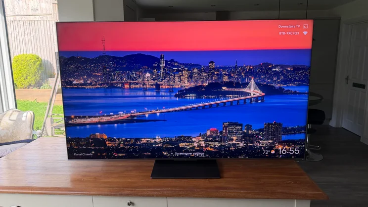 Front view of the TCL C8L SQD Mini LED TV depicting a bridge over a river