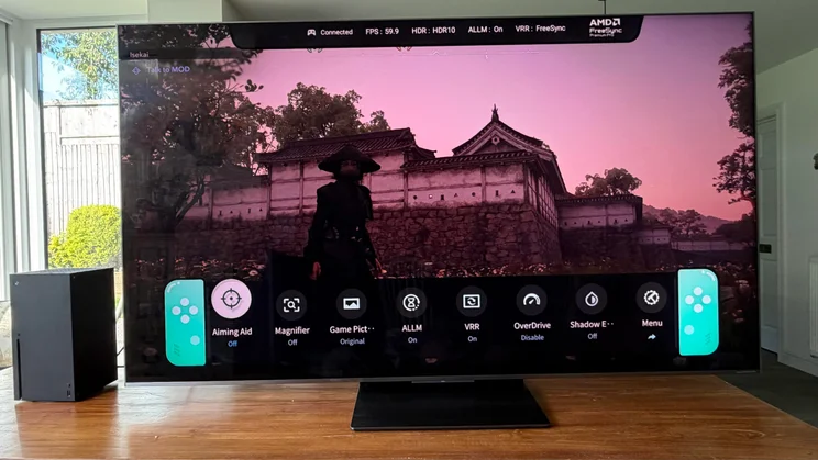 Front view of the TCL C8L SQD Mini LED TV displaying gameplay from the Xbox Series X