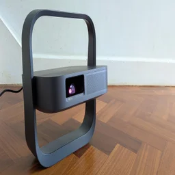 The XGIMI Elfin Flip Laser projector on a wooden floor facing to the right