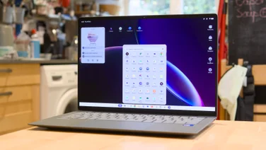 Front three-quarter view of the open Asus Googlebook 14 showing the ChromeOS app launcher and a Calendar and tasks widget over a purple wallpaper.