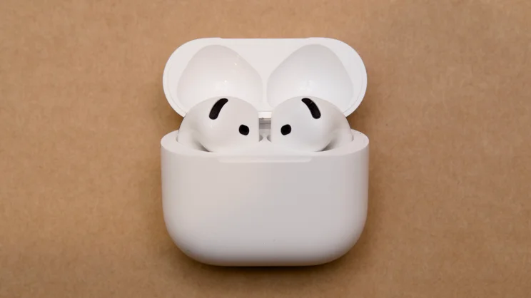 Apple AirPods 5 charging case with the lid open, showing both earbuds seated in the case