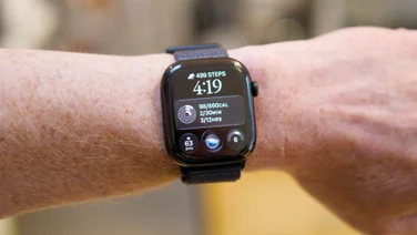 Apple Watch Series 12 on a wrist showing 499 steps, the time 4:19, Activity stats, a 63 BPM heart rate and Readiness 6.