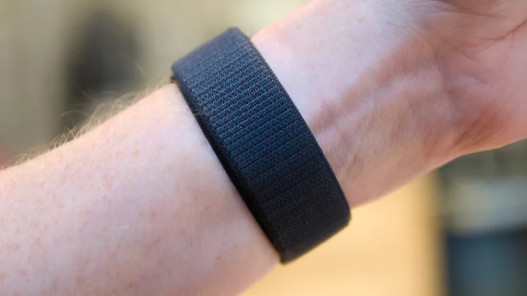 Close-up of the midnight woven Sport Loop band of an Apple Watch Series 12 fastened around a wrist.