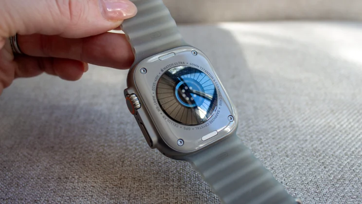 Hand holding the Apple Watch Ultra 4 to show the back, with the new heart rate sensor