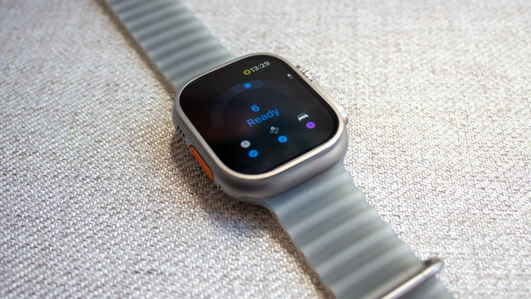 Apple Watch Ultra 4 on woven fabric showing the new Readiness app on screen, with a score of 6