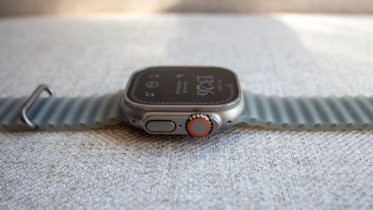 Side-on view of the Apple Watch Ultra 4 with the orange-ringed Digital Crown and side button