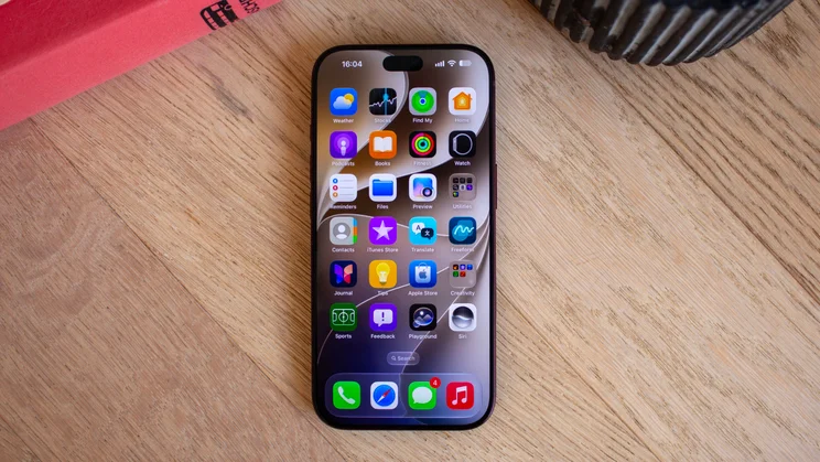 iPhone 18 Pro home screen showing a grid of app icons including Weather, Stocks, Find My, Home, Podcasts, and Books