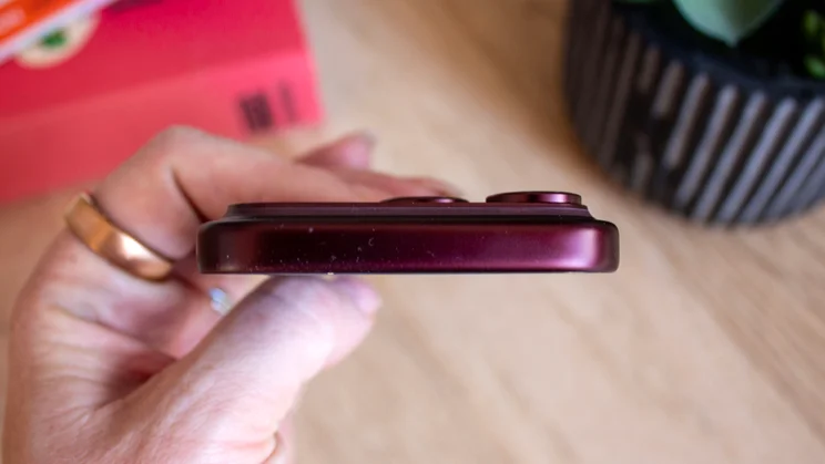 Close-up of the top corner of a burgundy iPhone 18 Pro's camera module, showing the flash and lens detail