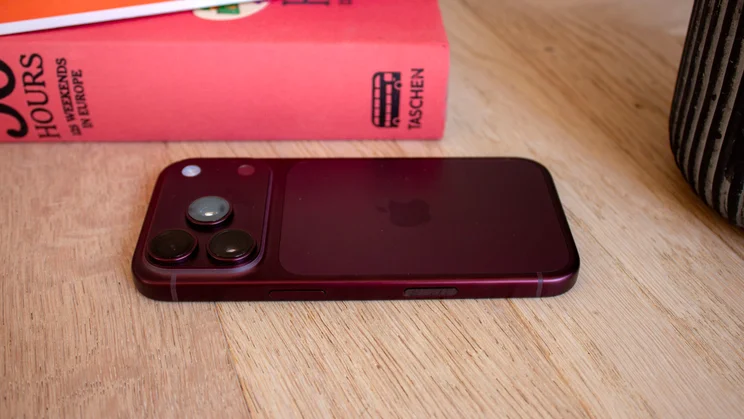 Back of a burgundy iPhone 18 Pro lying flat, with a close-up view of the triple-camera module and flash