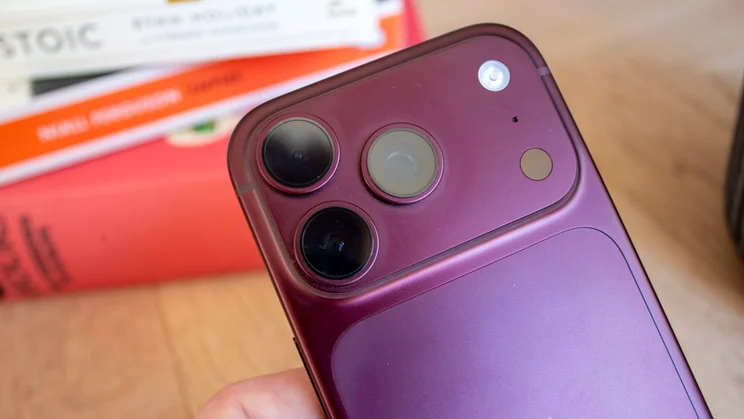 Close-up of the top corner of a burgundy iPhone 18 Pro's camera module, showing the flash and lens detail