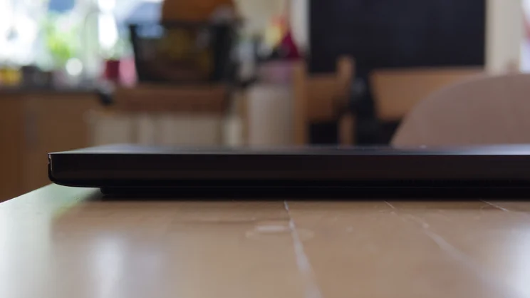 Rear edge of the closed Asus ProArt P16 RTX Spark laptop, showing the slim hinge, exhaust vents and small 'Designed by ASUS' lettering.