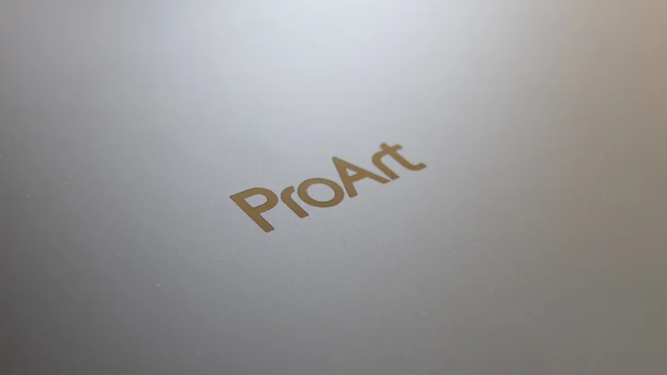 Close-up of the gold ProArt logo on the grey lid of the Asus ProArt P16 RTX Spark laptop.