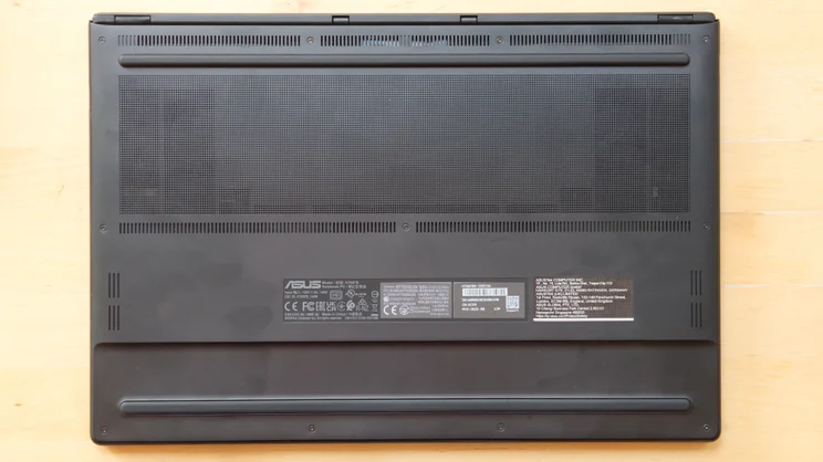 Underside of the Asus ProArt P16 RTX Spark laptop, showing the large perforated ventilation grille, rubber feet and regulatory labels with model number H7607B.