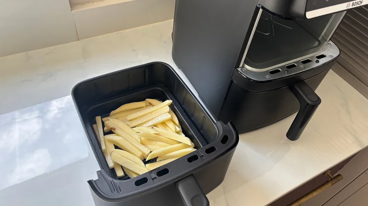 A bird's eye view of raw chips in the drawer of the Bosch Series 6 Double Stack Drawer Air Fryer