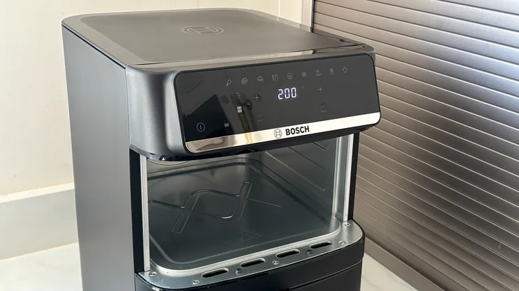 A closeup of the Bosch Series 6 Double Stack Drawer Air Fryer on a kitchen worktop. The top drawer has been removed, revealing its interior cavity