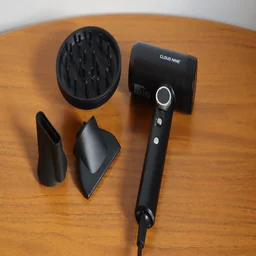 The Cloud Nine Airshot Pro Adapt hair dryer on a wooden table, alongside its attachments