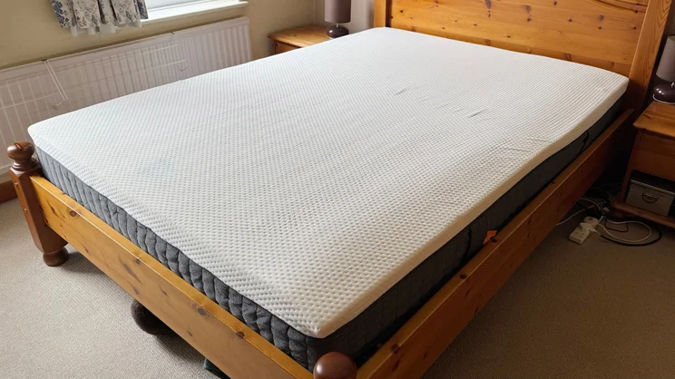 The Emma Original mattress on a wooden bed frame in a bedroom