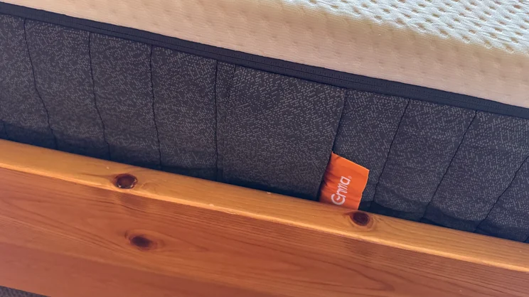 A closeup of the Emma Original mattress' side, and logo label