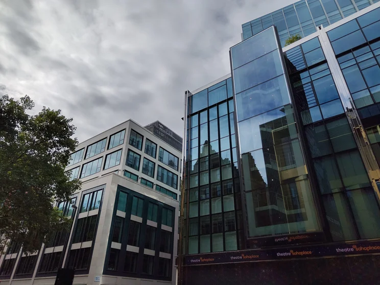 Buildings beneath a cloudy, grey sky
