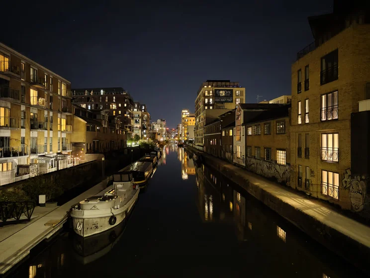 A river at night with buildings on both sides